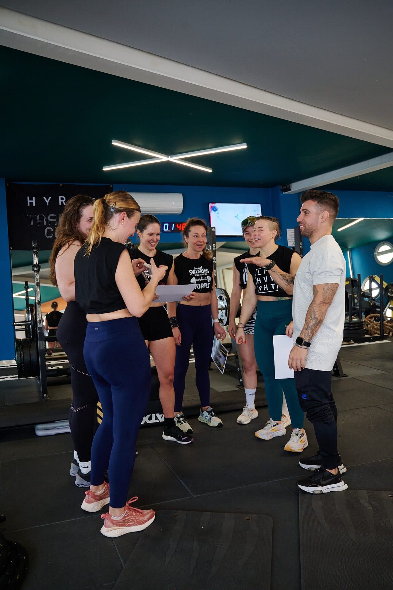 Coach briefing Hyrox athletes at VO2 Fitness Center