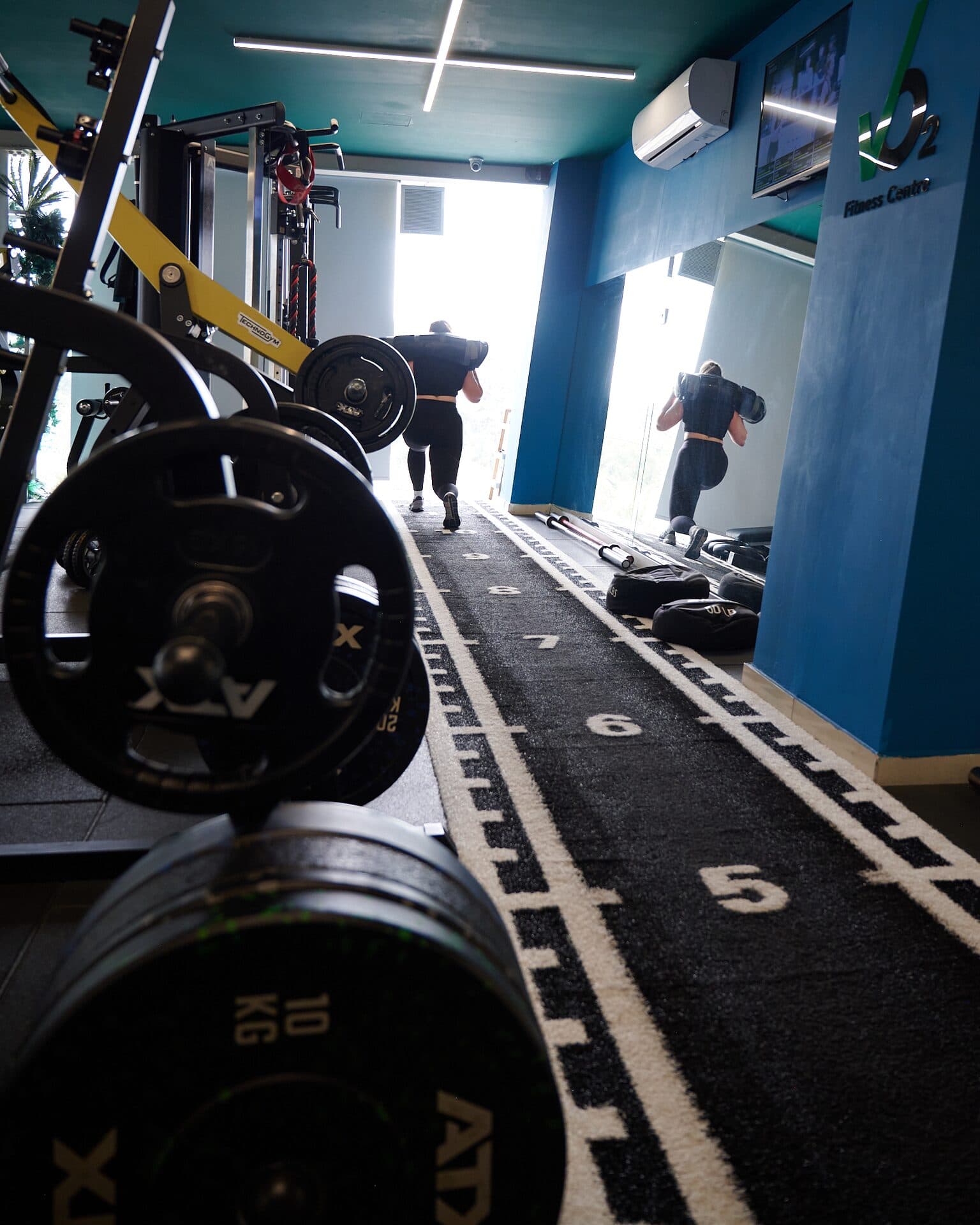 Athlete sprinting the Hyrox training lane at VO2 Fitness Center