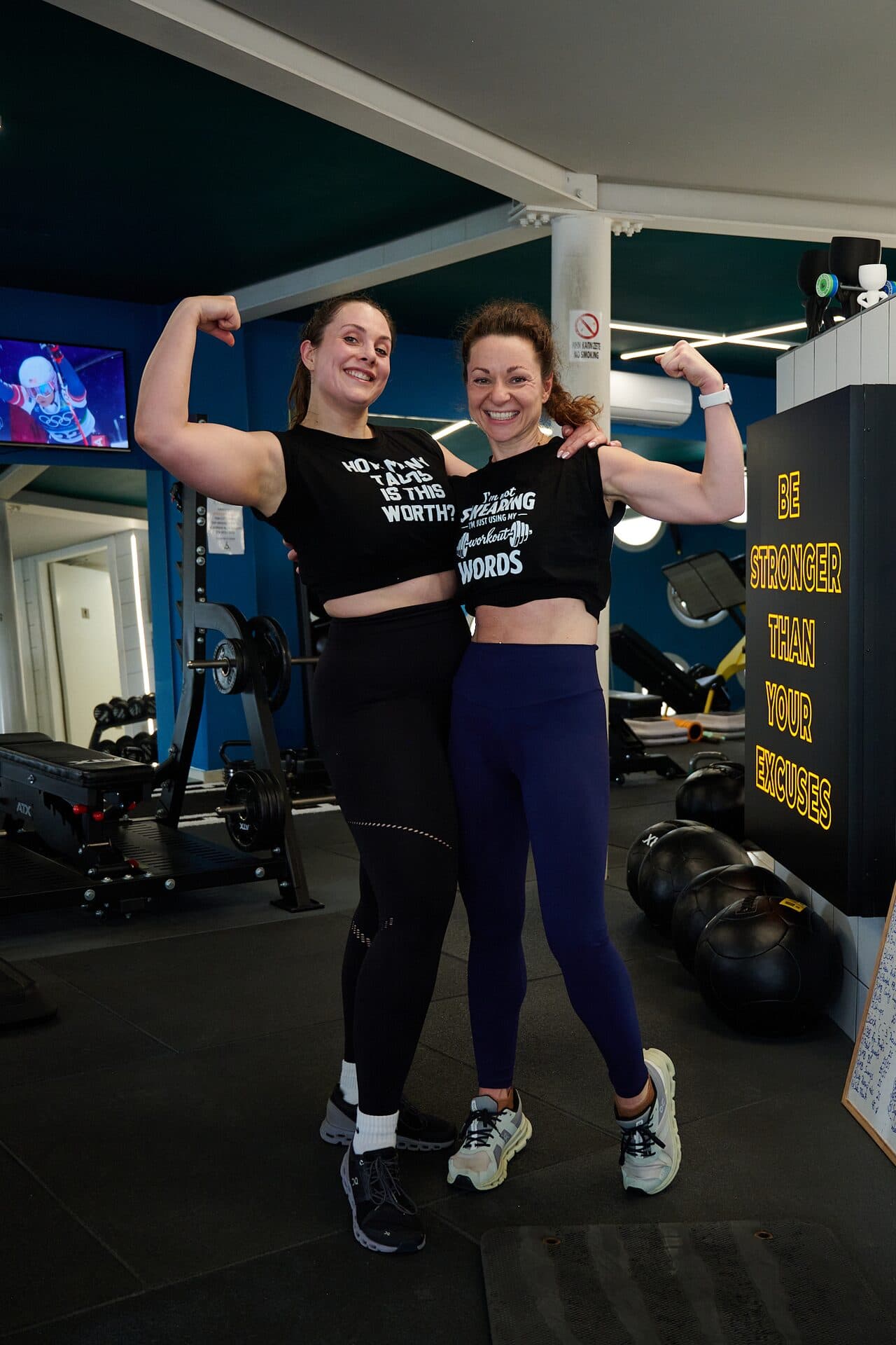 Two VO2 Hyrox athletes flexing after training