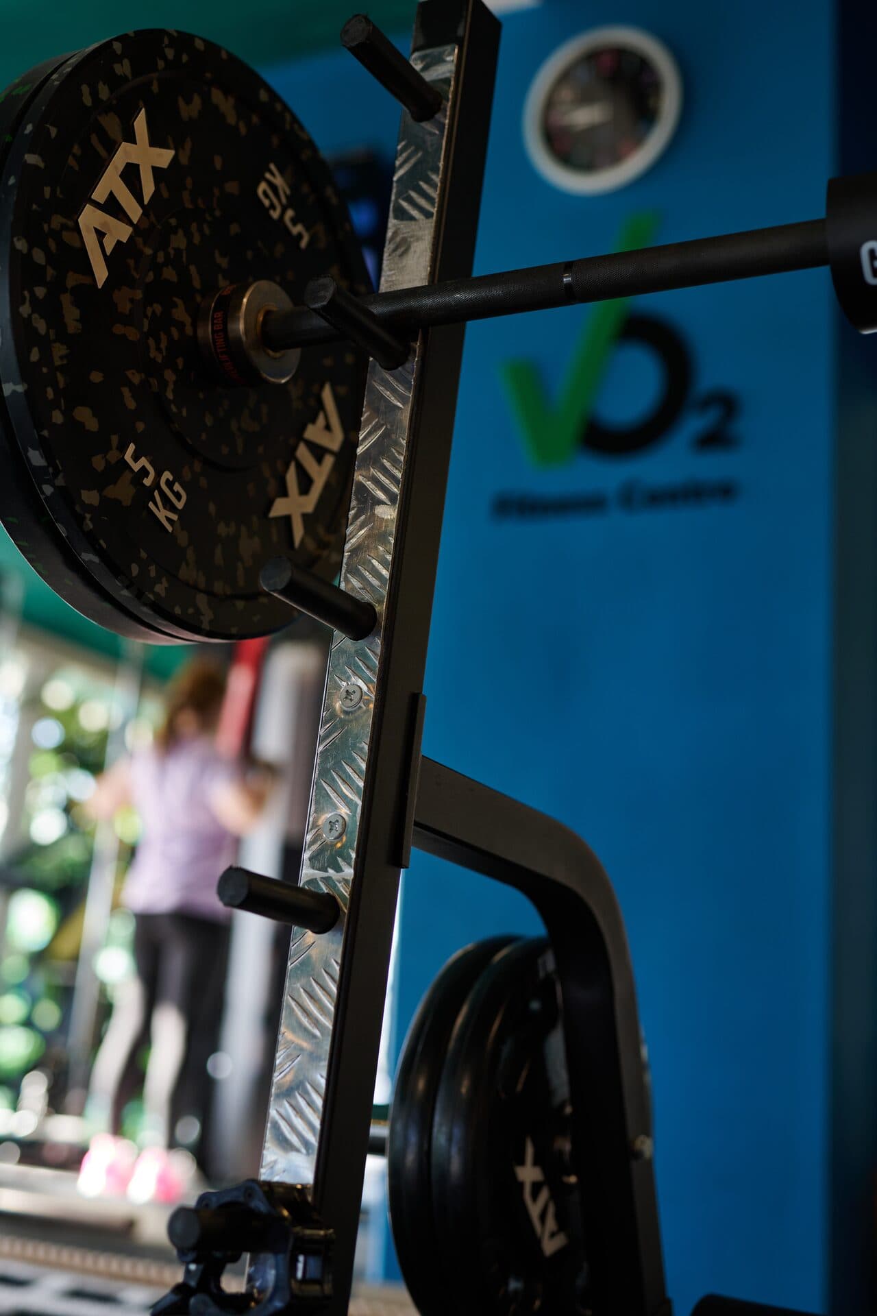 ATX rack with VO2 logo wall and athlete training behind